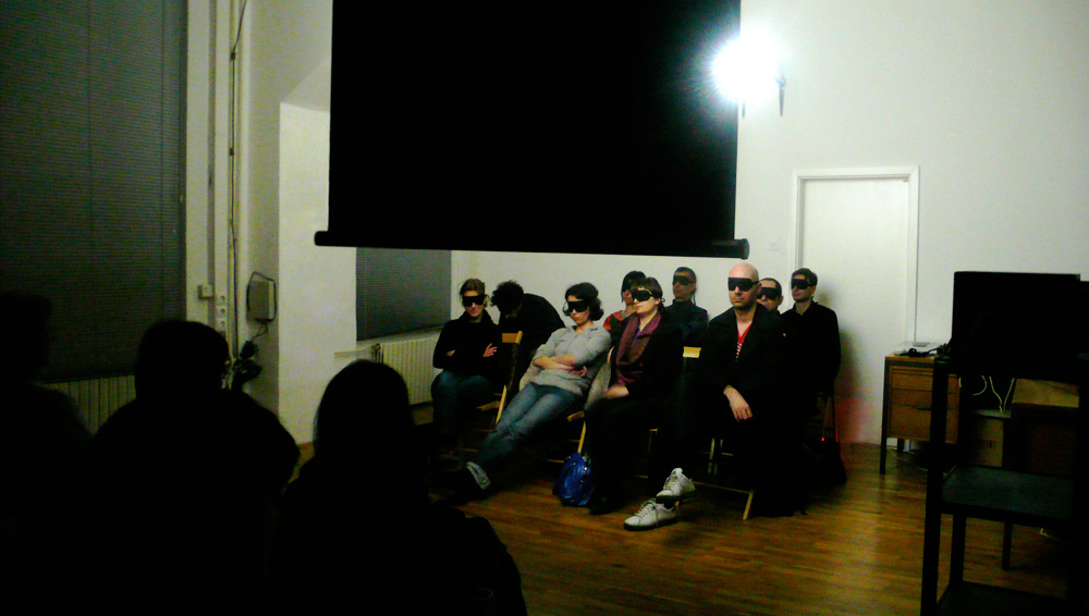 Art, artwork. An event entitled "Pollution in Art" by Nika Span / Nika Špan. Material: A sound recording, loudspeakers, a DVD, a DVD-player, a video projector, eye masks, a canvas screen. Duration approx. 20'. Project: No Nails, No Pedestals, Project Room, SCCA, Ljubljana, Slovenia